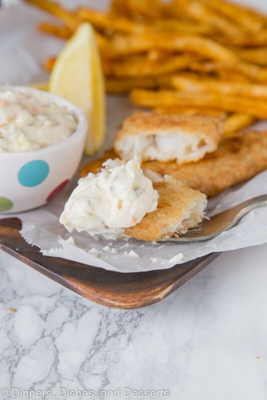 bite of fish with tarter on a plate