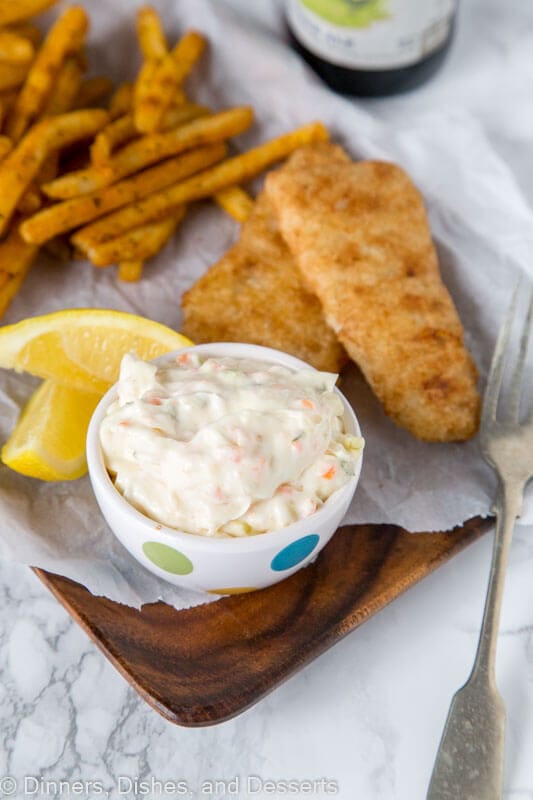 A plate of food, with Tartar sauce and Fish and chips