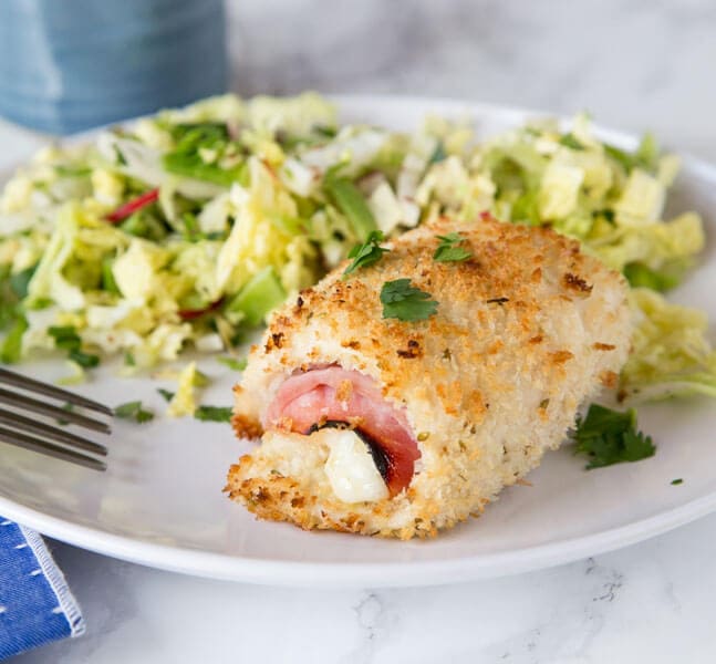 A plate of food, with Chicken and Cordon bleu and salad