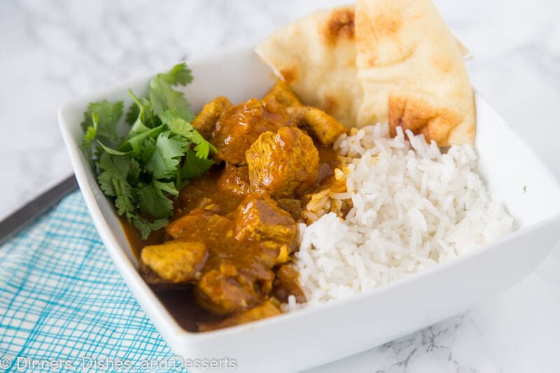 A bowl of rice on a plate, with Curry and Chicken