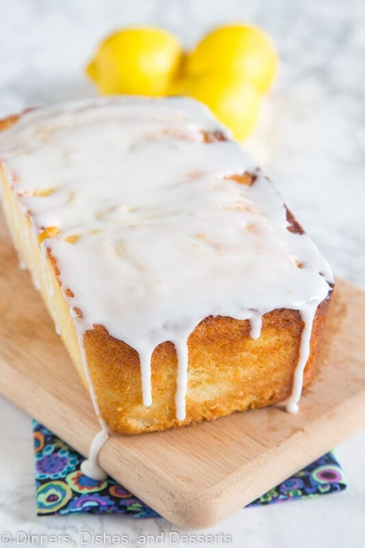 loaf cake with glaze sitting on a cutting board