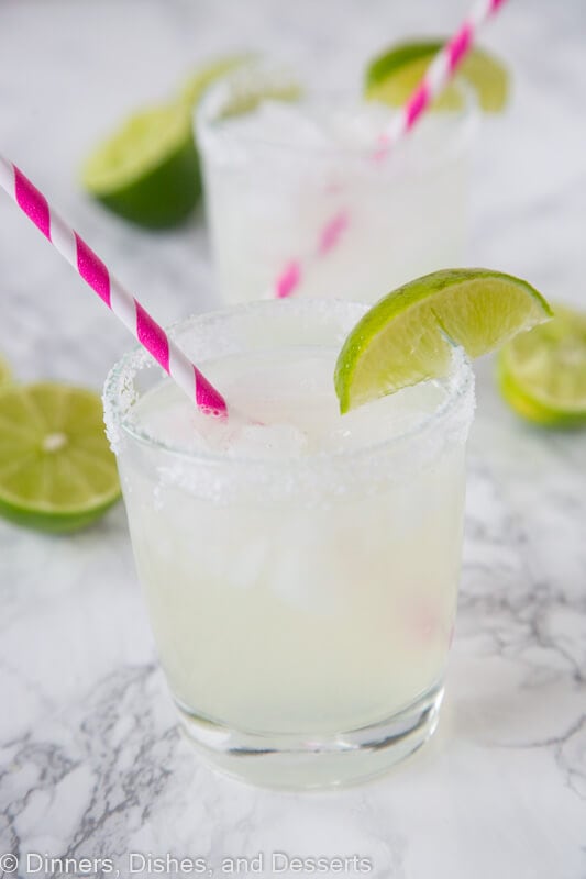 margarita in a glass with lime wedge and pink straw