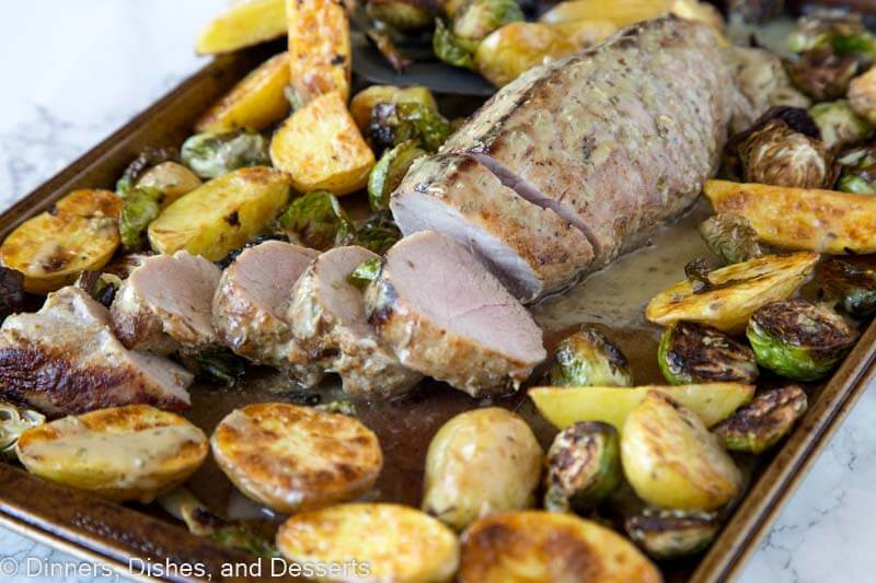 sheet pan with sliced Pork tenderloin with potatoes and brussels sprouts