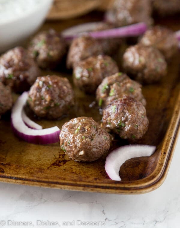 sheet pan of meatballs and red onions