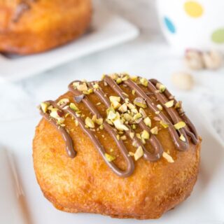 Nutella Donuts Recipe - make your own donuts at home using biscuits! They fry up quickly and are super easy. Filled with Nutella and topped with chopped pistachios.