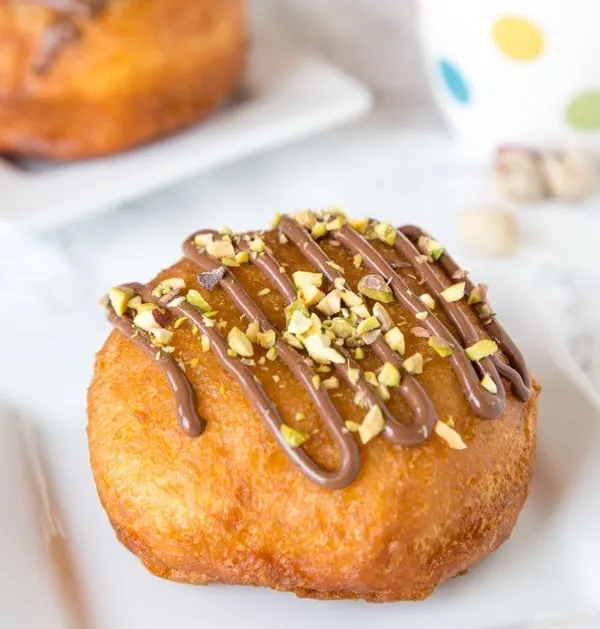 Nutella Donuts Recipe - make your own donuts at home using biscuits! They fry up quickly and are super easy. Filled with Nutella and topped with chopped pistachios.