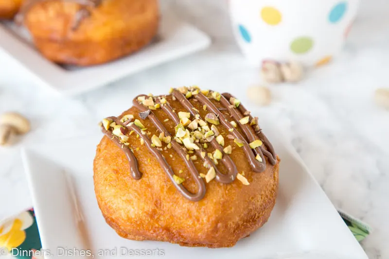 nutella donut on a plate with pistachios on top