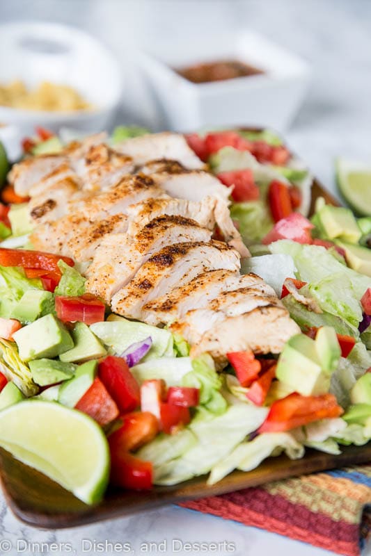 Chicken Fajita Salad - a hearty salad topped with grilled chicken, peppers, onion, avocados, and a salsa vinaigrette dressing. Definitely not your average salad!