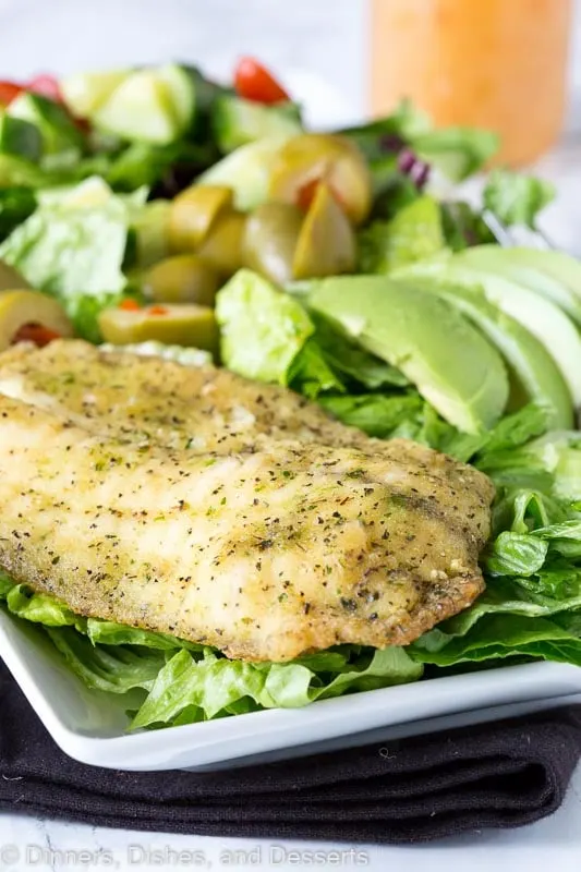 A salad with garlic herb fish with Garlic and Vinaigrette