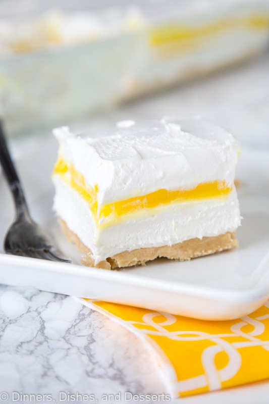 A piece of cake on a plate, with Lemon and Cream layers