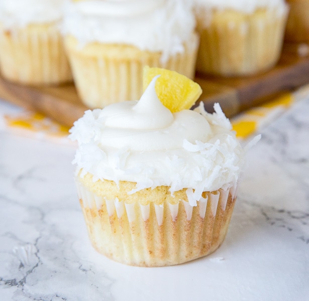 A close up of A close up pineapple cupcakes with coconut and pineapple piece