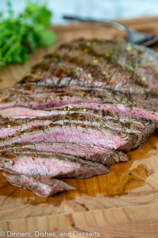 A close up of a plate of food with a slice cut out, with Steak and Grilling