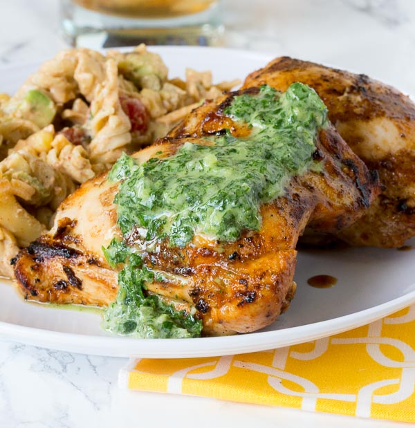 Grilled Chicken Thighs with Chile Herb Sauce - chicken thighs marinated in a blend of garlic, spices and lime juice. Grilled and then topped with a creamy herb and jalapeno sauce. 