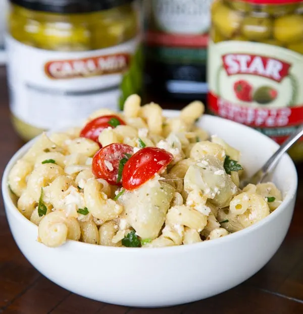 Mediterranean Pasta Salad - an easy pasta salad full of olives, artichoke hearts, tomatoes, parsley, and feta cheese. Topped with a light vinaigrette dressing for a cool and delicious dish. 