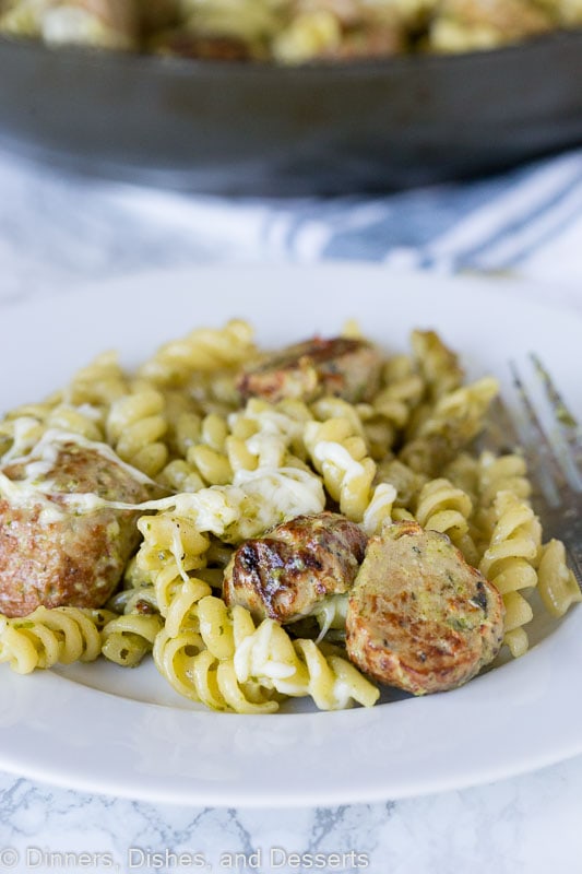 a plate of pesto pasta with meatballs