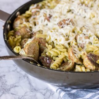 Pesto Pasta with Meatballs - a quick and easy dinner recipe with a creamy pesto sauce, pasta, a few meatballs, and plenty of cheese!