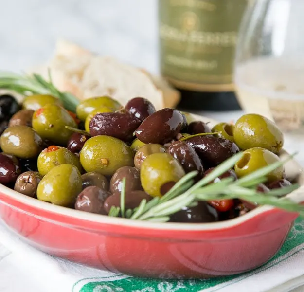 A bowl of olives and herbs