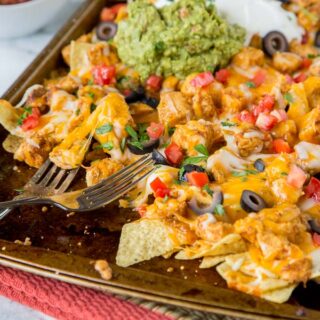 Sheet Pan Chicken Nachos - make a full tray of nachos for the whole family in minutes. Customize it to what your family likes, and get a dinner on the table, your family will love super fast!