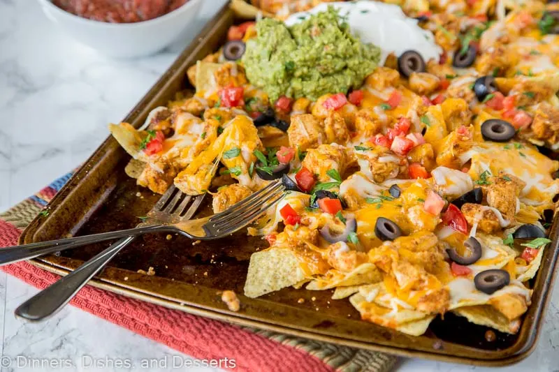 A tray of food on a table, with Nachos and Chicken