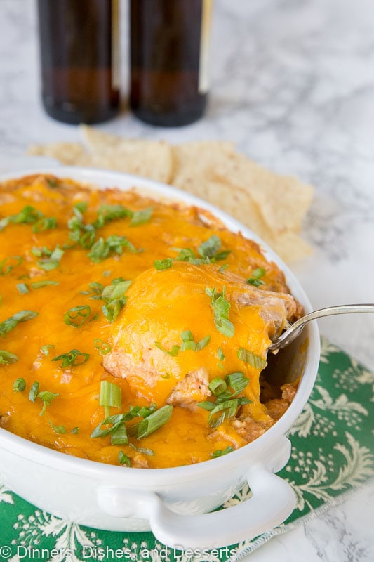 a spoon taking a scoop of chicken dip