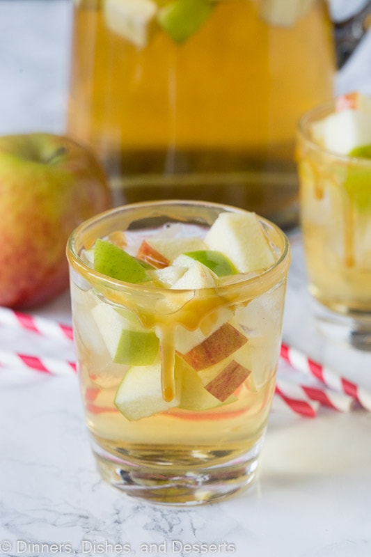 A close up of a glass cup on a table, with Sangria and Apple cider