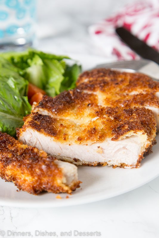 Crispy Pork Cutlet - tender boneless pork chops breaded and pan fried to crispy perfection. Served with a salad for a delicious meal any night of the week. 