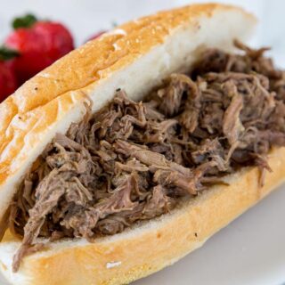 Slow Cooker Italian Beef - use your crock pot to make these super tender Italian Beef Sandwiches. Cooks all day in great spices, for a tender and flavorful dinner. 