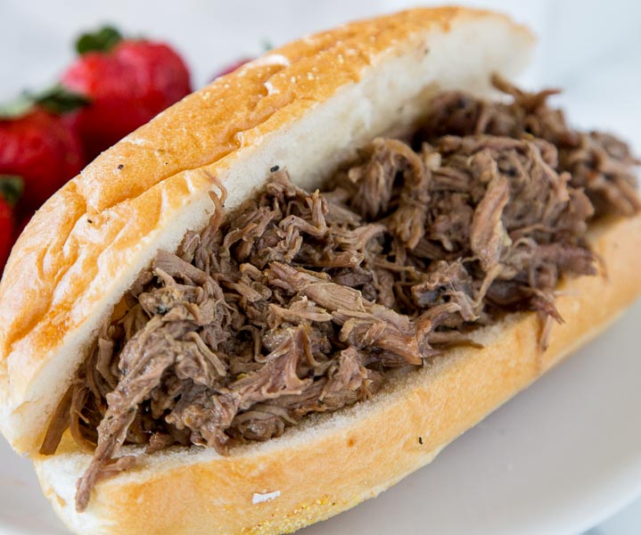 Slow Cooker Italian Beef - use your crock pot to make these super tender Italian Beef Sandwiches. Cooks all day in great spices, for a tender and flavorful dinner. 