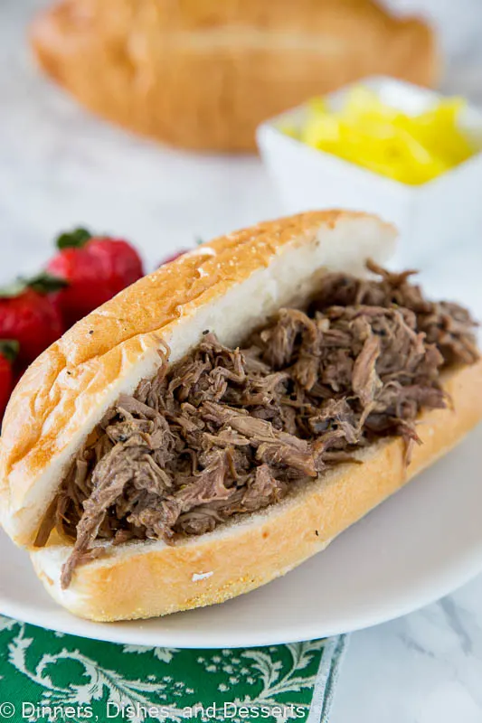 Slow Cooker Italian Beef - use your crock pot to make these super tender Italian Beef Sandwiches. Cooks all day in great spices, for a tender and flavorful dinner. 