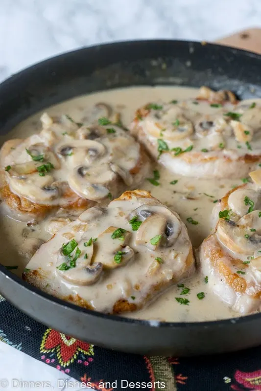 Smothered Pork Chops - a super easy boneless pork chops recipe with a creamy mushroom gravy over the top! Easy, comforting and delicious. 