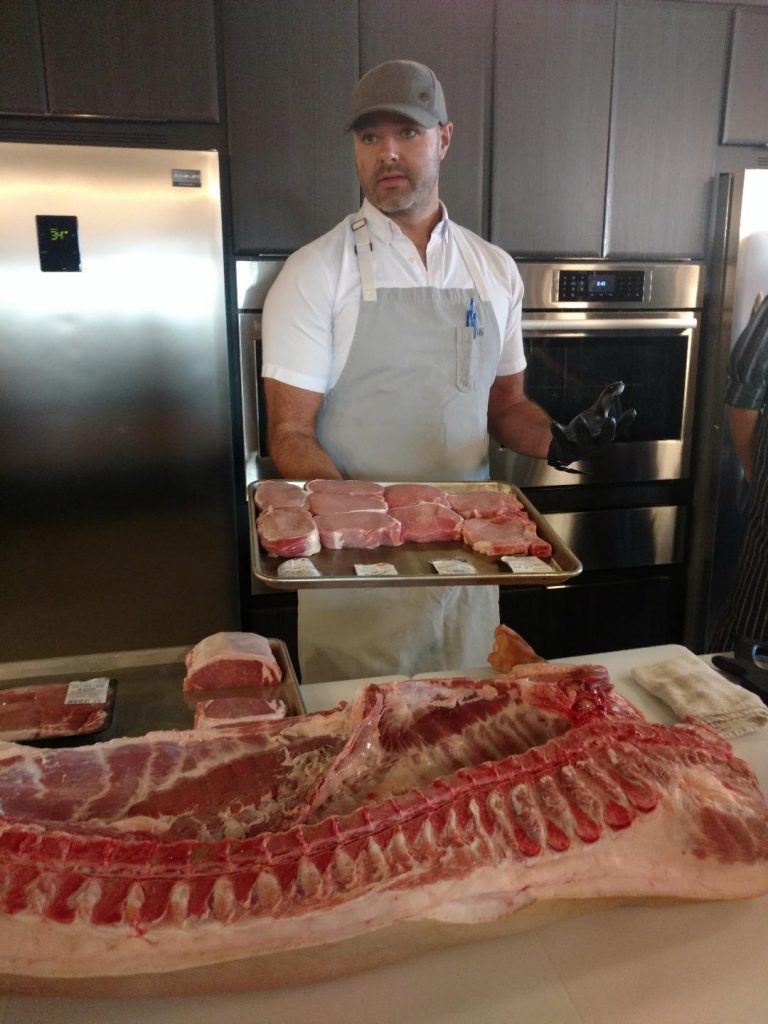 Chef Neel showing us the difference in pork chops.