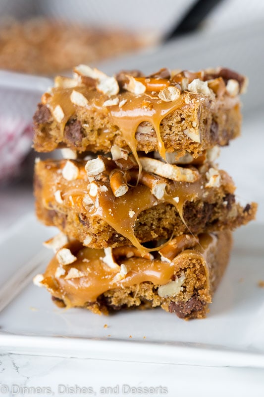 a close up of bars with melted caramel and pretzels