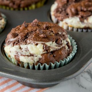 Double Chocolate Cheesecake Muffins - Rich, chocolate muffins with a layer of sweetened cream cheese for a light and tender breakfast or even dessert. 