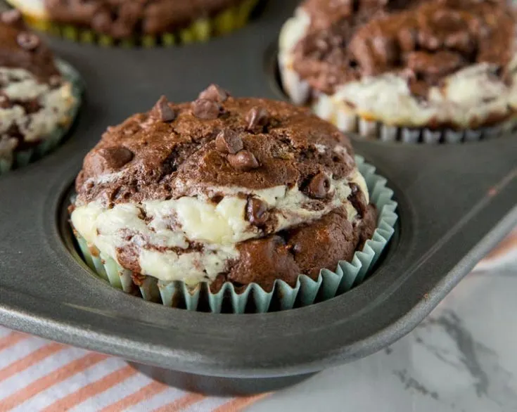 Double Chocolate Cheesecake Muffins - Rich, chocolate muffins with a layer of sweetened cream cheese for a light and tender breakfast or even dessert. 