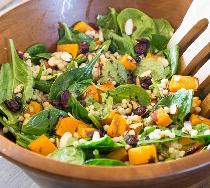 Fall Couscous Salad - Israeli couscous, spinach, butternut squash. cranberries and pecans all tossed with a balsamic vinaigrette. Great fall salad for the holidays, potlucks, or just because.