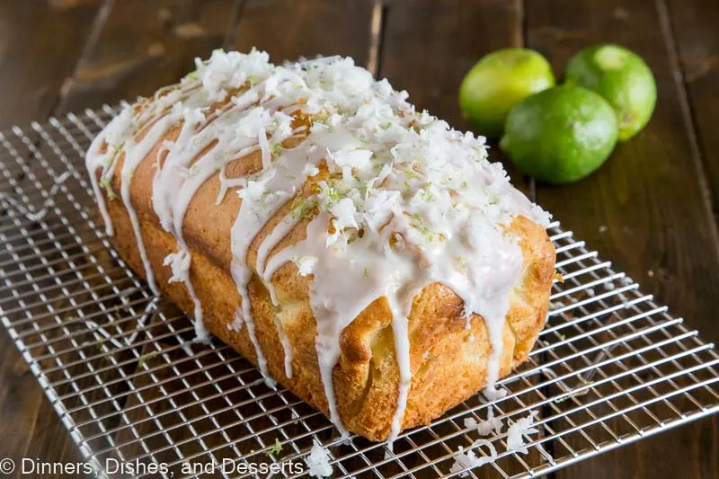 Loaf of coconut lime quick bread sitting on cooling rack