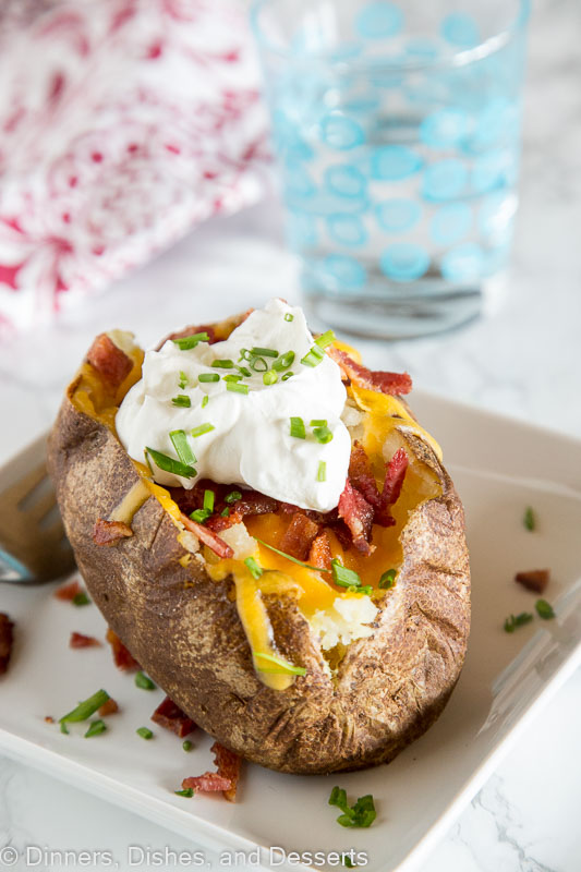 Loaded Baked Potato Recipes - perfect baked potatoes that are topped with cheese, bacon, sour cream and chives! A great side dish or even dinner idea! 