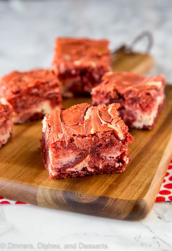 red velvet brownies with cream cheese swirl on a cutting board
