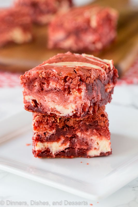 A close up of red velvet brownies with cream cheese swirl
