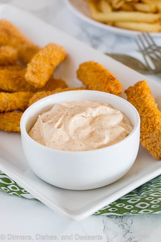 A plate of dipping sauce with fish sticks