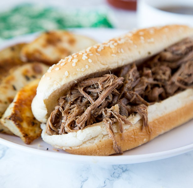A close up of a french dip sandwich on a plate