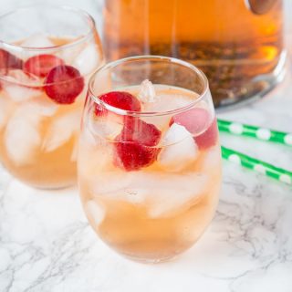 Strawberry Rum Punch Recipe - a fun cocktail with strawberries, white rum, ginger ale and strawberry sparkling wine. Fizzy, refreshing and great for any occasion.