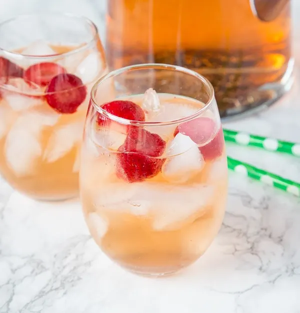 Strawberry Rum Punch Recipe - a fun cocktail with strawberries, white rum, ginger ale and strawberry sparkling wine. Fizzy, refreshing and great for any occasion.