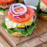 A close up of a burger on a cutting board
