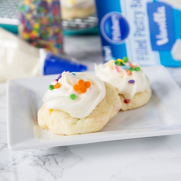 Frosted Funfetti Cake Mix Cookies - super easy and soft funfetti cookies topped with a swirl of vanilla frosting and more sprinkles. These cake mix cookies come together in minutes and are sure to impress!