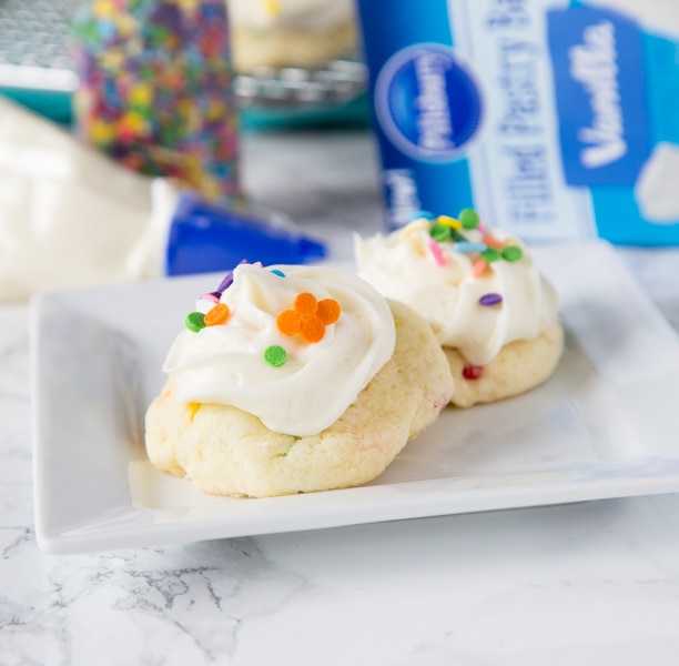 Frosted Funfetti Cake Mix Cookies - super easy and soft funfetti cookies topped with a swirl of vanilla frosting and more sprinkles.  These cake mix cookies come together in minutes and are sure to impress!