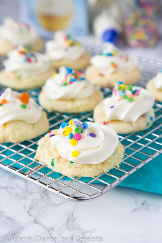 A close up of cookies with frosting on a cooling rack