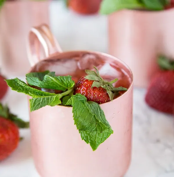 Strawberry Moscow Mule - strawberries giving a classic Moscow Mule a sweet and fun twist!  Whip these up today, they are perfect to sip on any day of the week!  