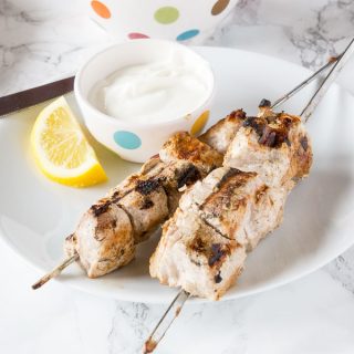 Yogurt Marinated Pork Kebobs - pork tenderloin cubes marinated in Greek yogurt and warm spices.  Grilled to perfection and served with a lemon yogurt sauce!  Up your summer grilling game!