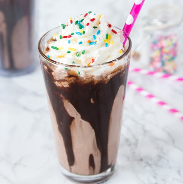 Chocolate Milkshake Recipe - the best way to cool off this summer with a homemade chocolate milkshake topped with whipped cream and sprinkles!